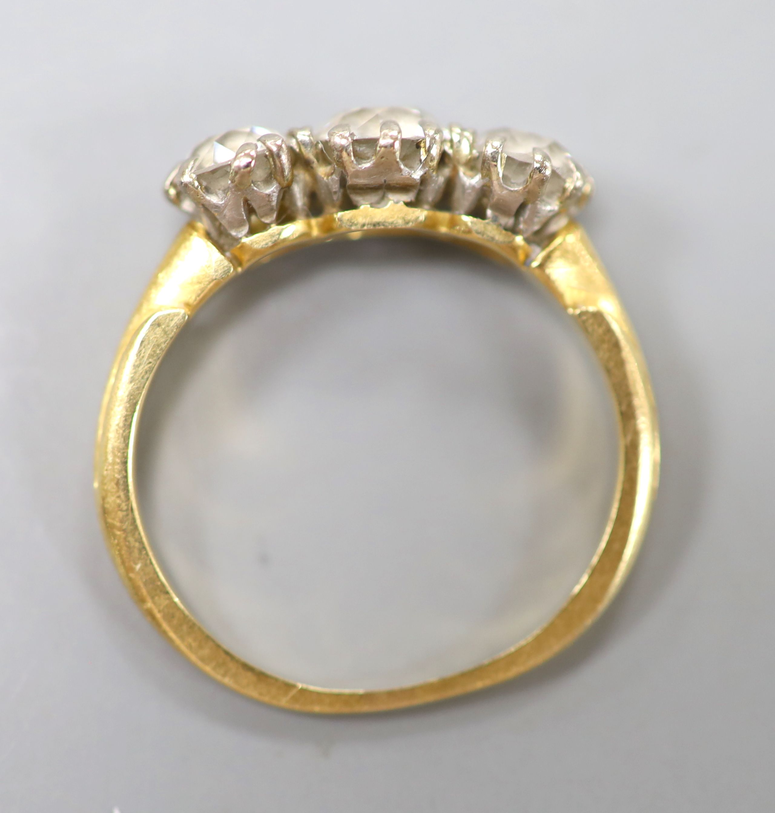A yellow metal and three stone diamond ring, size L, gross weight 3.3 grams